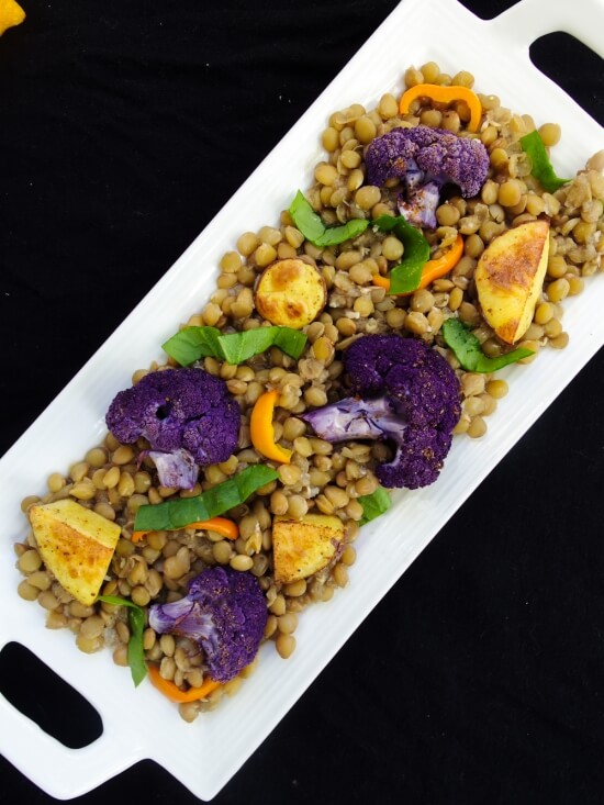 Persian spiced lentils with sweet roasted purple cauliflower, potatoes, onion, bell pepper, and currants or raisins, with a sweet coconut sugar and a spicey baharat blend