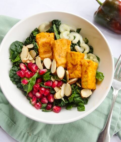 Creamy Ranch Kale Salad with fluffy Buffalo Tofu and fresh vegetables, fruits, and nuts - this healthy kale preparation trick will have you loving this green | yupitsvegan.com
