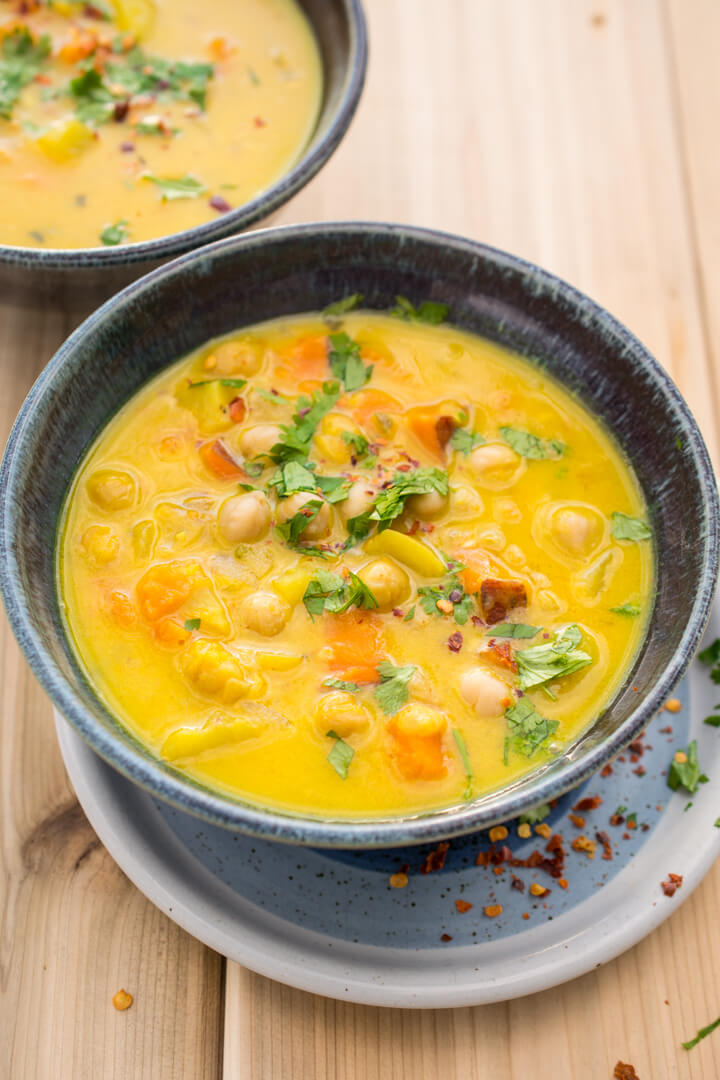 A serving of chickpea turmeric stew in a ceramic bowl.