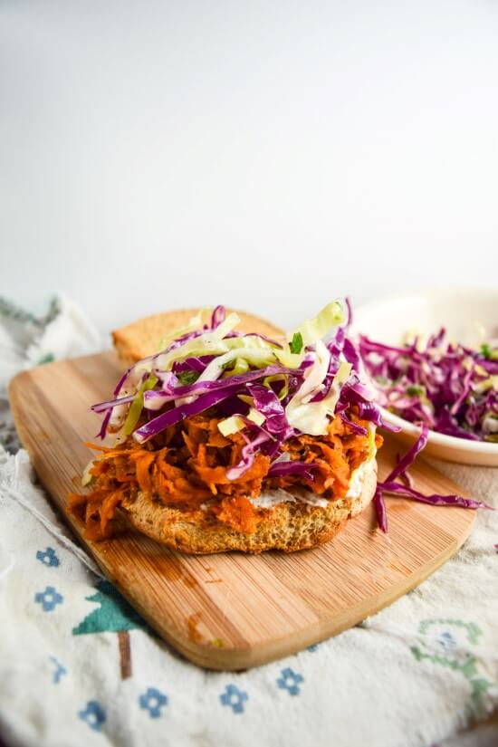 Homemade barbecue sauce smothered tender browned sweet potato shreds topped with crunchy fresh vegetables make a comforting and filling delicious vegan meal