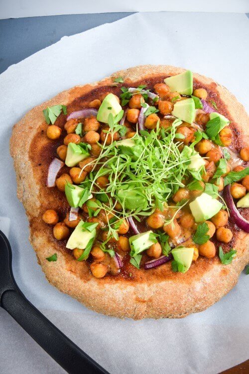 BBQ Chickpea Pizza | yupitsvegan.com. Crispy and fluffy pizza crust smothered with BBQ sauce and topped with chickpeas, red onions, avocados, and fresh herbs.