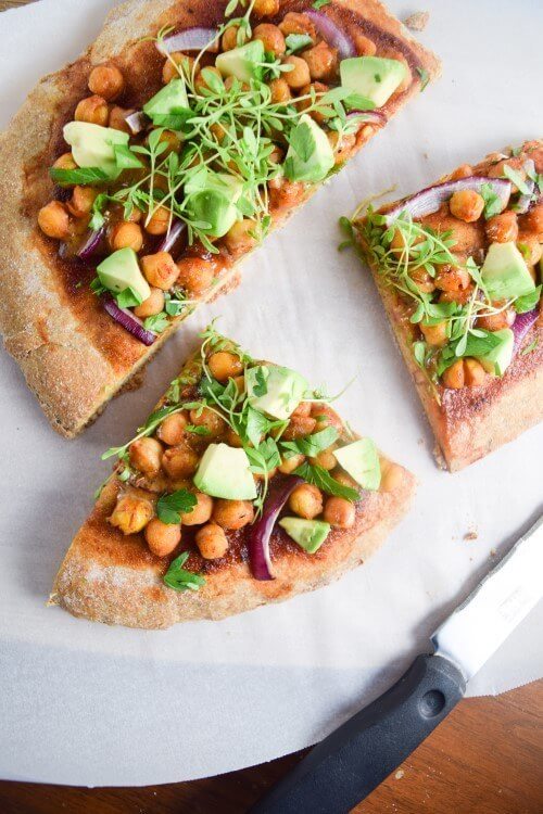 BBQ Chickpea Pizza | yupitsvegan.com. Crispy and fluffy pizza crust smothered with BBQ sauce and topped with chickpeas, red onions, avocados, and fresh herbs.