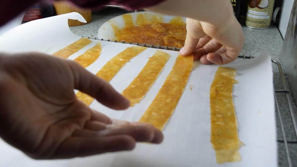 Lay out the strips of rice paper bacon on parchment paper for a light and crispy finish