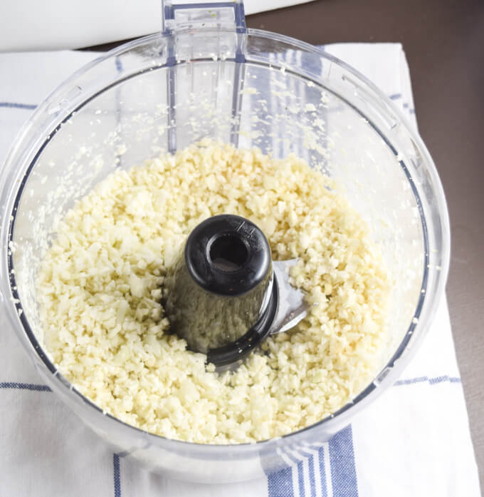 Cauliflower rice in preparation - cauliflower, olive oil, and a food processor make a healthy low carb substitute 