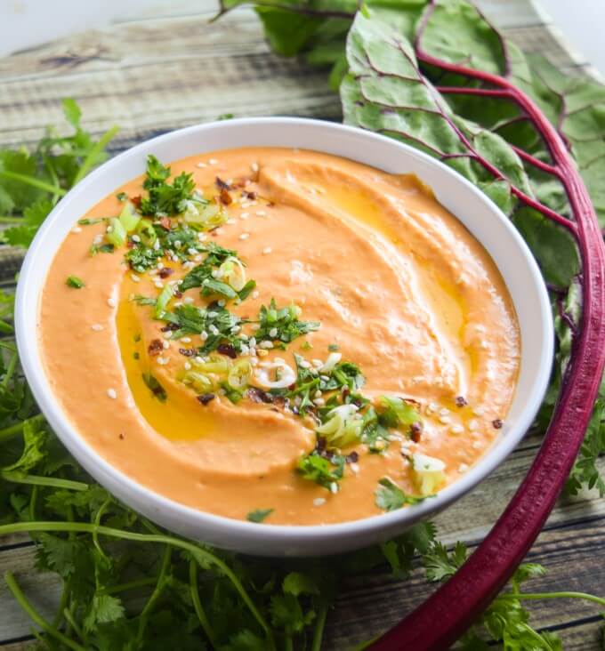 Roasted red pepper white bean hummus, made dreamily light and smooth without any added oil and without peeling the beans! Vegan, gluten-free recipe.