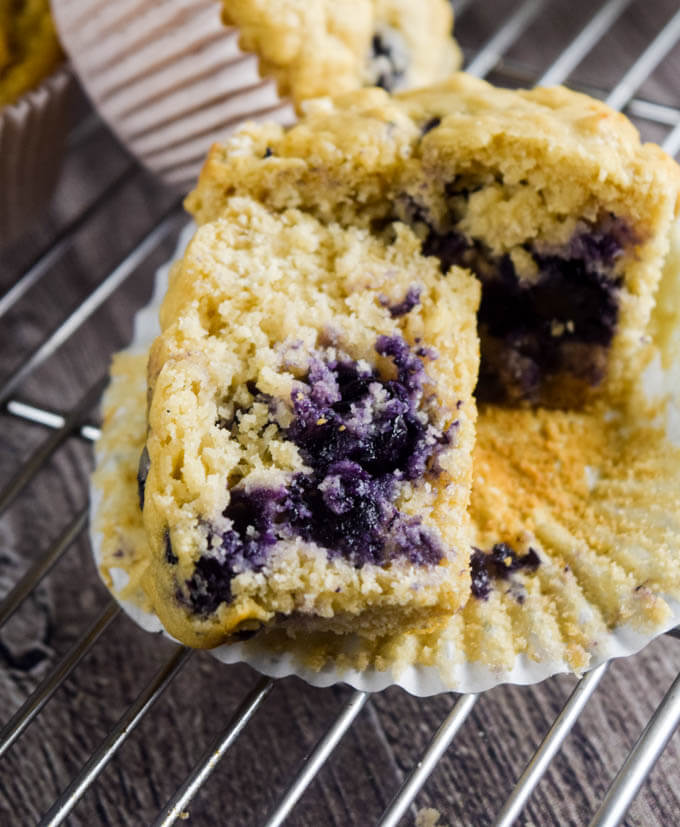 Close up of the tight crumb of a lemon muffin exploding with sweet fresh blueberries - perfect breakfast or dessert