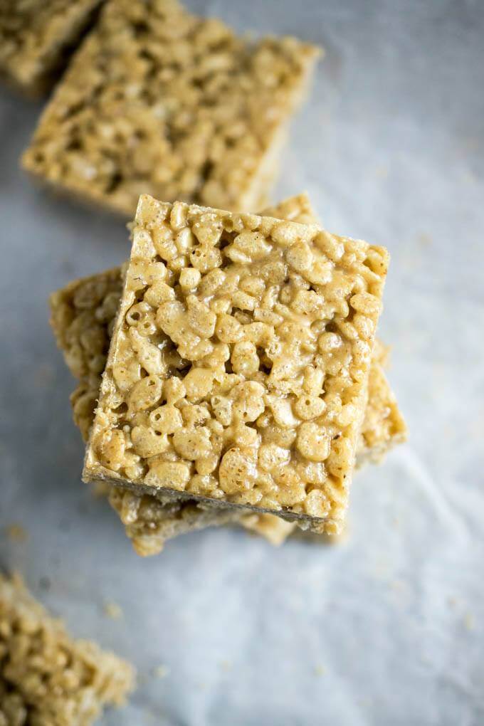 A stack of perfect oil-free, gluten-free squares of white chocolate almond butter rice cereal treats with delicious vegan breakfast rice crisps