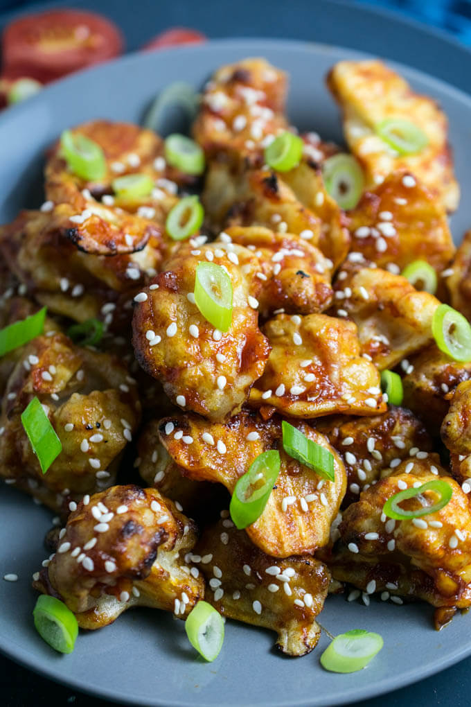 Sticky Sesame Cauliflower | Yup, it's Vegan. Baked battered cauliflower smothered in a sweet and spicy sauce.
