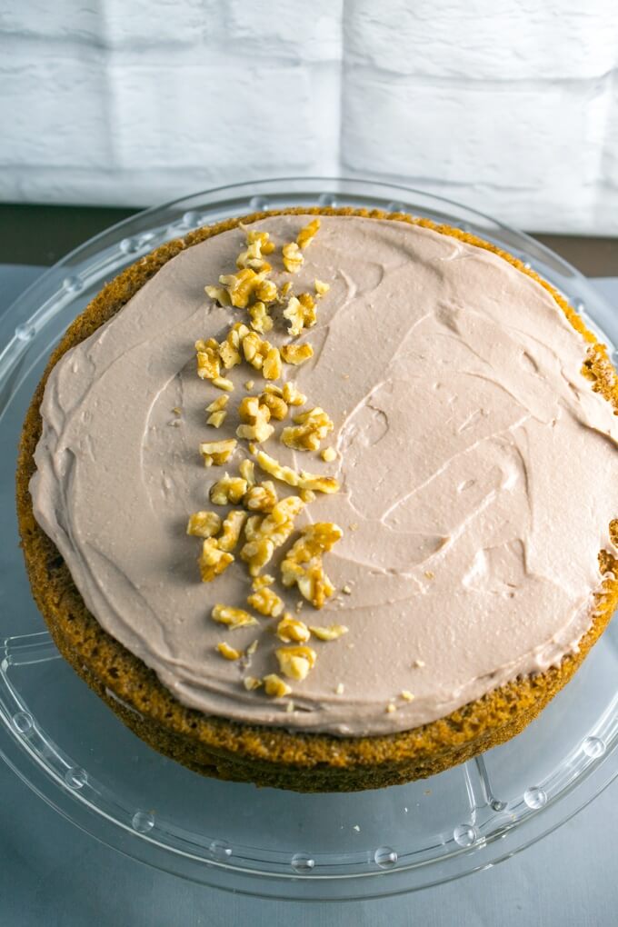 Sweet potatoes replace carrots in this twist on a classic cake! Spread thick with a toasted walnut frosting and garnished with crunchy nuts for a light and sweet spring dessert