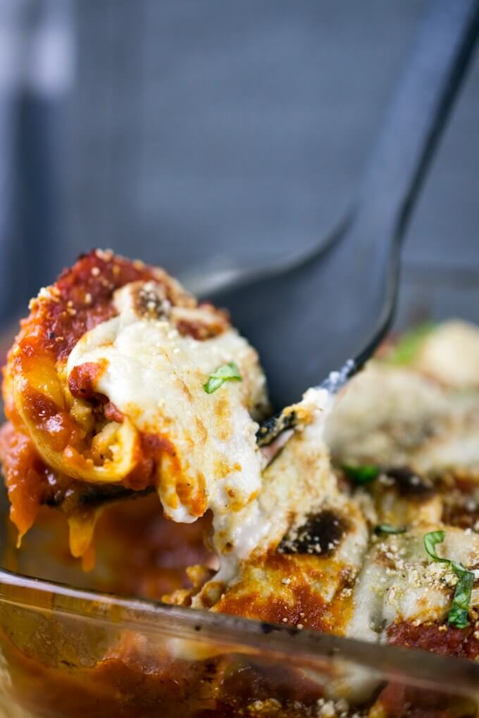 Close-up of vegan stuffed shells with red arrabbiata sauce, cashew cheese, and almond ricotta.