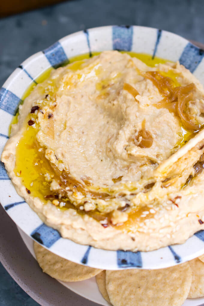 Caramelized onion hummus in a bowl drizzled with olive oil