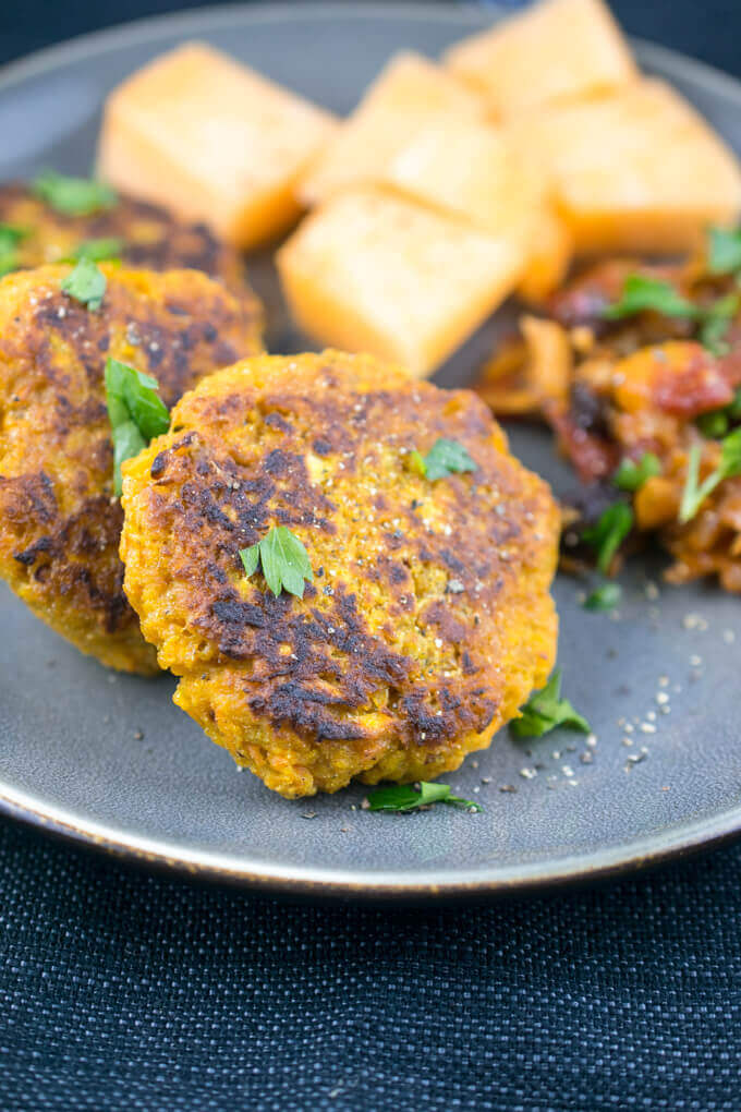Curried carrot fritter garnished with black pepper and fresh cilantro