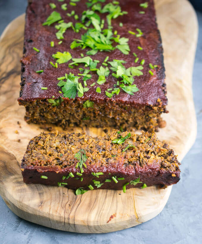 A thick slice of lentil loaf with the tender interior visible