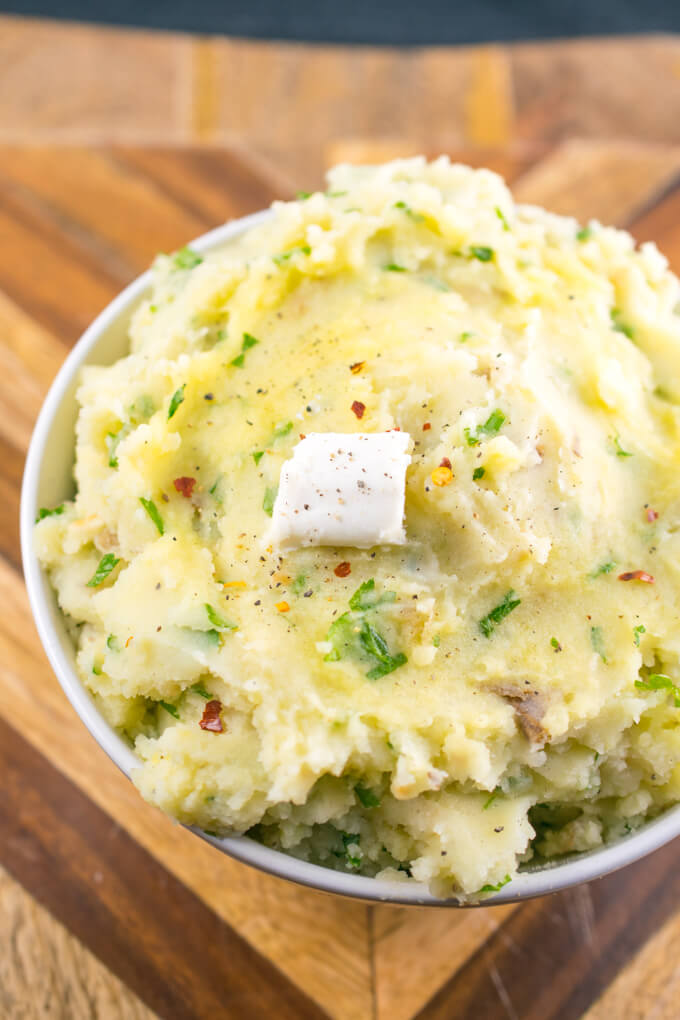 Close-up of vegan mashed potatoes with a pat of dairy-free butter and a sprinkle of pepper