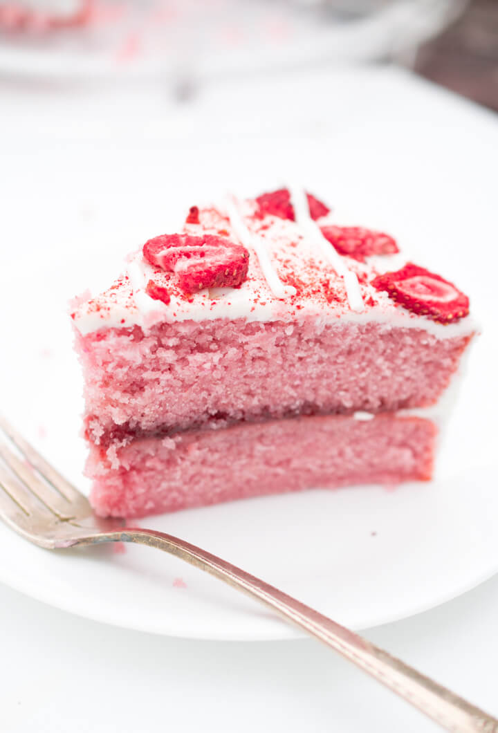 Close-up of a slice of vegan strawberry cake showing the delicate crumb texture.