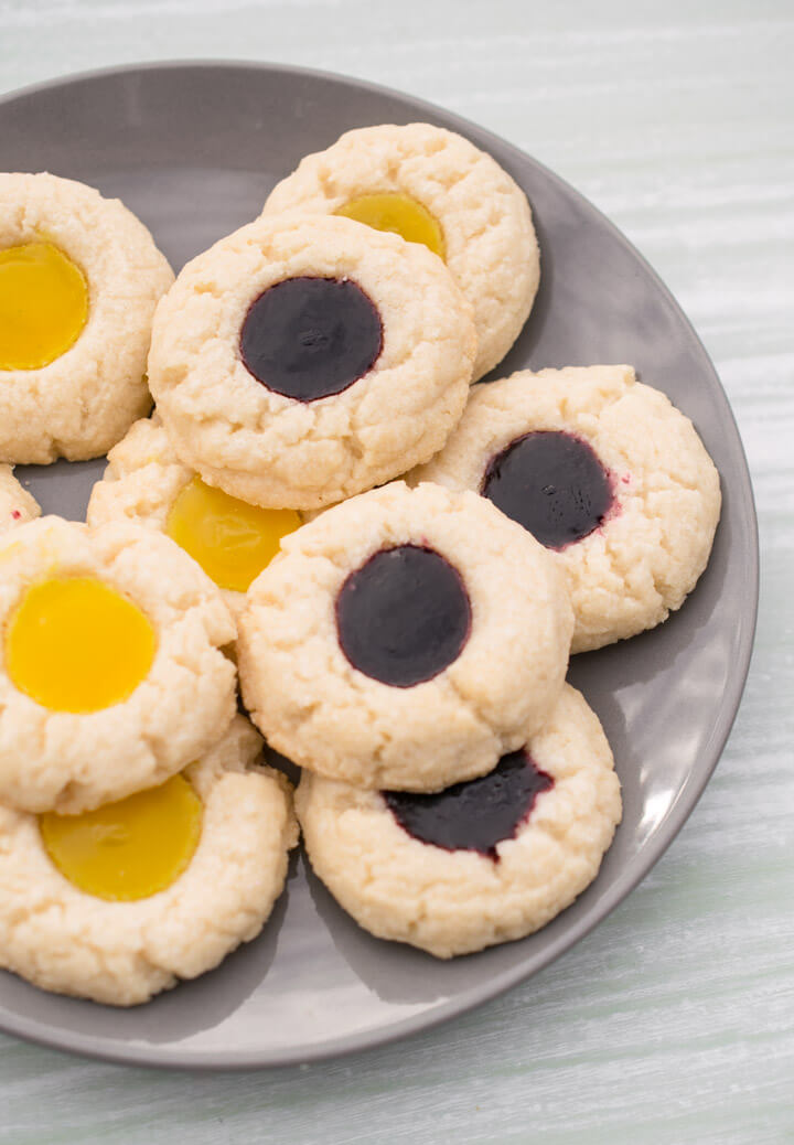 Several vegan thumbprint cookies on a gray plate